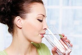 The girl drinks water in the diet for the lazy